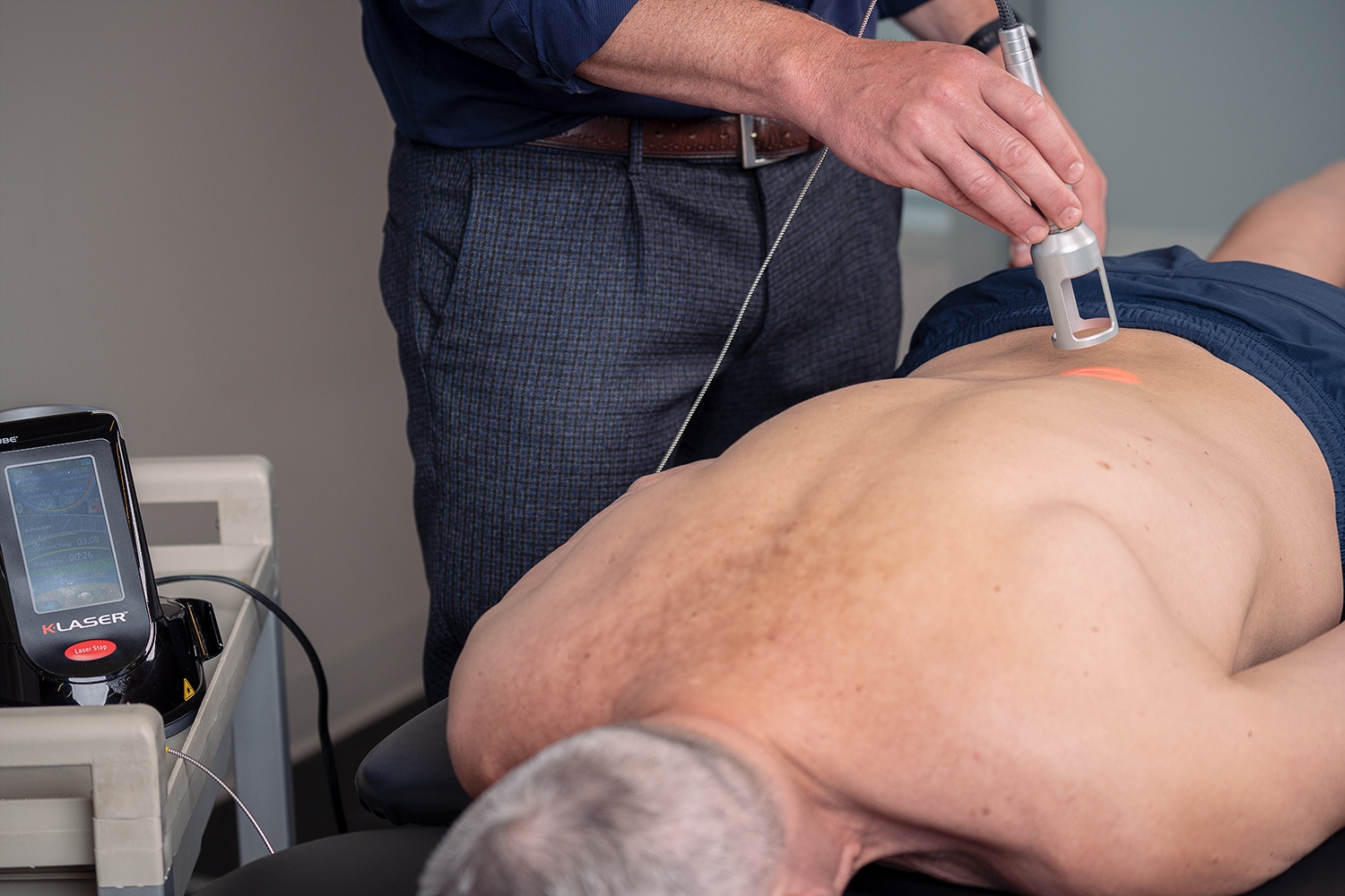 Physiotherapist doing a class iv laser treatment