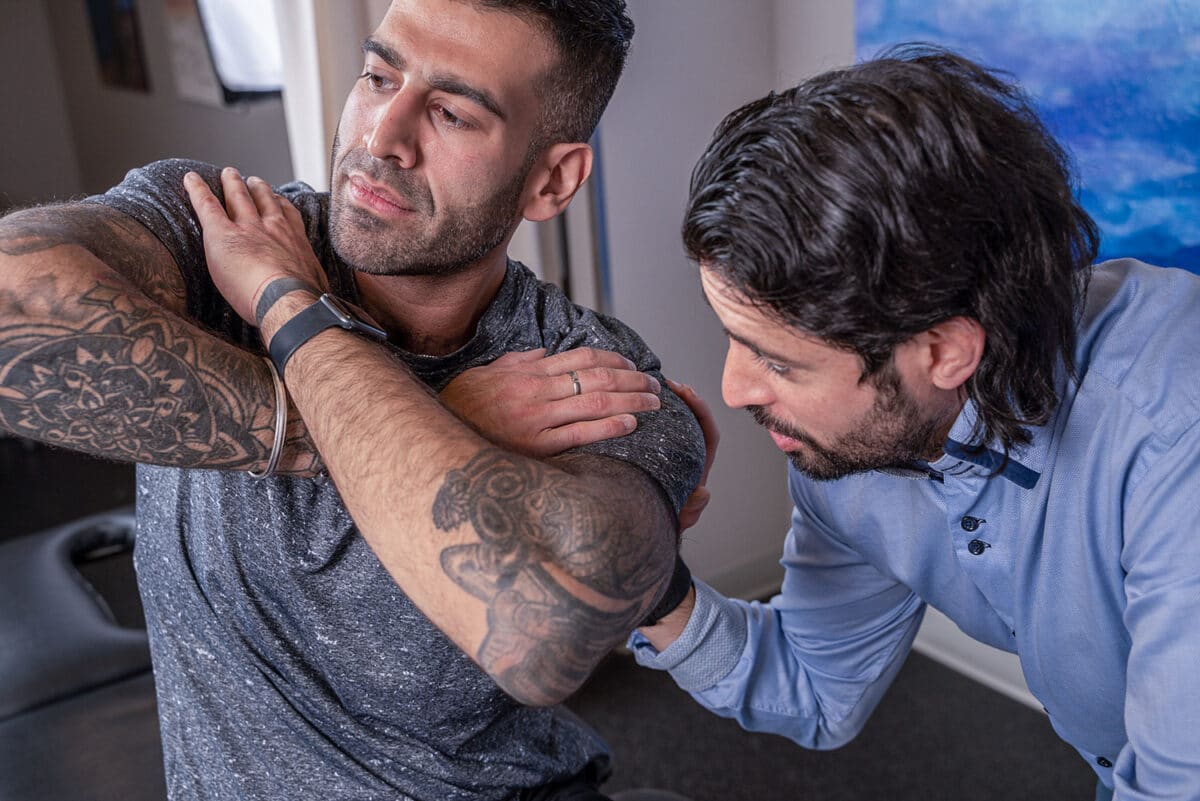 Calgary Core Physiotherapist Elliott Goldman working with a client on rotation